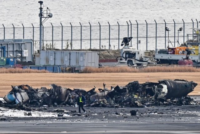Japan probes plane inferno after 'miracle' escape