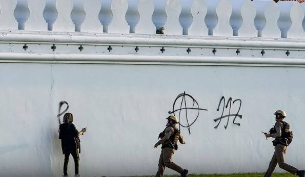 Two reporters in police custody over defacing of a Royal temple wall Two reporters in police custody over defacing of a Royal temple wall