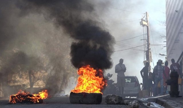 Haiti capital 'paralyzed' after unrest, PM still abroad Haiti capital 'paralyzed' after unrest, PM still abroad