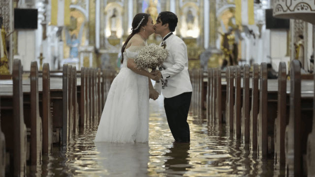 Filipino couple walking down a flooded aisle on their wedding day Filipino couple walking down a flooded aisle on their wedding day